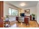 Bright home office featuring a unique desk, plants, and beautiful hardwood flooring at 9650 W 35Th Ave, Wheat Ridge, CO 80033