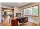 Bright home office featuring a spacious wooden desk and large window overlooking the outdoors at 9650 W 35Th Ave, Wheat Ridge, CO 80033