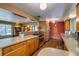 Bright kitchen with wooden cabinetry, stainless steel appliances, and seamless connection to the dining area at 9650 W 35Th Ave, Wheat Ridge, CO 80033