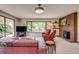 Spacious living area with large windows, comfortable seating, and a brick fireplace for a cozy atmosphere at 9650 W 35Th Ave, Wheat Ridge, CO 80033