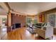 Cozy living room with a unique brick fireplace, hardwood floors, and large windows for ample natural light at 9650 W 35Th Ave, Wheat Ridge, CO 80033