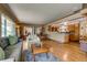 Open-concept living area featuring hardwood floors, modern furnishings, and seamless flow to dining and kitchen at 9650 W 35Th Ave, Wheat Ridge, CO 80033