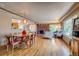 Open-concept living and dining area with hardwood floors, a brick fireplace, and modern decor at 9650 W 35Th Ave, Wheat Ridge, CO 80033