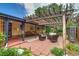 Brick patio with pergola, outdoor furniture, and a view of the landscaped backyard at 9650 W 35Th Ave, Wheat Ridge, CO 80033