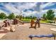 Community playground with a slide, play structures, and pea gravel surfacing at 9650 W 35Th Ave, Wheat Ridge, CO 80033