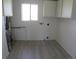 Utility room with hookups, cabinets and window for natural light at 5660 Olive St, Commerce City, CO 80022