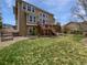 Beautiful backyard features a well-maintained lawn, mature trees, and a spacious deck at 23559 Branston Ln, Parker, CO 80138