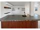 Basement bar area features stone counters, shelving, and accent lighting at 23559 Branston Ln, Parker, CO 80138