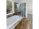 Luxurious bathroom featuring a soaking tub, glass-enclosed shower, and tiled walls at 23559 Branston Ln, Parker, CO 80138