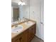 Bathroom with double sink vanity, mirror, and a shower/tub combination at 23559 Branston Ln, Parker, CO 80138