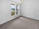 Cozy bedroom with neutral carpet and bright windows, offering ample natural light at 23559 Branston Ln, Parker, CO 80138