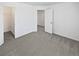 Carpeted bedroom with white walls, an open doorway, and a walk-in closet at 23559 Branston Ln, Parker, CO 80138