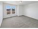 Comfortable bedroom with neutral carpet and large windows, providing plenty of sunlight at 23559 Branston Ln, Parker, CO 80138