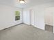 Clean bedroom with gray carpet, one window, and a white door to another room at 23559 Branston Ln, Parker, CO 80138
