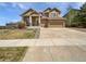 Charming two-story home boasts stone accents, a three-car garage, and well-maintained landscaping at 23559 Branston Ln, Parker, CO 80138