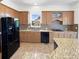 Modern kitchen with granite countertops, wood cabinets, and stainless steel appliances at 23559 Branston Ln, Parker, CO 80138