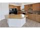 Well-equipped kitchen featuring granite countertops, wood cabinets, and a central island with seating at 23559 Branston Ln, Parker, CO 80138