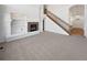 Spacious living room features a fireplace, built-in shelves, and a staircase at 23559 Branston Ln, Parker, CO 80138
