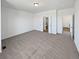 Large main bedroom with neutral carpet leading to the en-suite bathroom and walk-in closet at 23559 Branston Ln, Parker, CO 80138