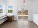 Bright office space with built-in desk, tile flooring, and sliding glass door to a deck at 23559 Branston Ln, Parker, CO 80138