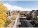 Aerial view of a residential neighborhood with modern townhouses and city skyline in the background at 3437 W 17Th Ave, Denver, CO 80204