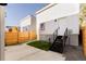 Private backyard with a concrete patio, wooden fence, and modern townhouse exterior at 3437 W 17Th Ave, Denver, CO 80204