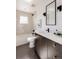 Spa-like bathroom with dark vanity and a walk-in shower at 3437 W 17Th Ave, Denver, CO 80204