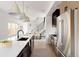 Modern kitchen with island, stainless steel appliances, and light wood cabinets at 3437 W 17Th Ave, Denver, CO 80204