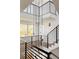 Modern staircase with metal railings and pendant lighting at 3437 W 17Th Ave, Denver, CO 80204