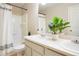 Well-lit bathroom featuring a double sink vanity, bathtub with shower, and stylish decorative accents for a relaxing experience at 13915 Ivanhoe St, Thornton, CO 80602