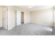 Bright bedroom with neutral carpet, a doorway and a large window, offering a comfortable and inviting space at 13915 Ivanhoe St, Thornton, CO 80602