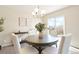 Inviting dining room featuring an elegant chandelier and sliding glass door to a patio at 13915 Ivanhoe St, Thornton, CO 80602