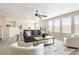 Bright living room with modern ceiling fan and comfortable seating area, with great natural light at 13915 Ivanhoe St, Thornton, CO 80602