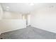 Spacious loft area with neutral carpet and paint, offering a versatile space for a playroom or additional living area at 13915 Ivanhoe St, Thornton, CO 80602