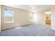 Serene main bedroom with large windows, neutral carpet, and an ensuite bathroom, offering a peaceful retreat at 13915 Ivanhoe St, Thornton, CO 80602