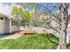 Well-maintained backyard featuring a wooden deck, lush green lawn, and a white privacy fence at 13244 Quivas St, Denver, CO 80234