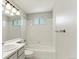 Bright bathroom with white tile, a tub-shower combo, and a modern vanity at 13244 Quivas St, Denver, CO 80234