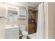 Bathroom featuring a shower with colorful tiles, a vanity, and natural light at 13244 Quivas St, Denver, CO 80234
