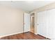 Bedroom with hardwood floors, closet, baseboard trim and a door to the hallway at 13244 Quivas St, Denver, CO 80234