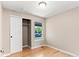 Bedroom with hardwood floors, window, baseboard trim, and closet at 13244 Quivas St, Denver, CO 80234