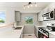 Bright kitchen featuring stainless steel appliances, light cabinets, and a window view at 13244 Quivas St, Denver, CO 80234