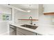 Kitchen featuring stainless steel appliances, light gray cabinets, and a sink with a window view at 13244 Quivas St, Denver, CO 80234