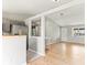 Open living room with wood floors, light gray paint, stainless steel appliances, and lots of light at 13244 Quivas St, Denver, CO 80234