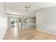 Bright living room features light wood floors, neutral walls, and sliding glass doors for natural light at 13244 Quivas St, Denver, CO 80234