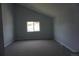 A carpeted bedroom with a large window and neutral wall paint at 8832 Lipan St, Thornton, CO 80260