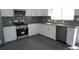 Well-lit kitchen featuring new stainless steel appliances and granite countertops at 8832 Lipan St, Thornton, CO 80260