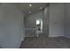 Carpeted living room with vaulted ceiling and open access to other rooms at 8832 Lipan St, Thornton, CO 80260
