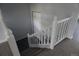 Carpeted staircase with white wood railing leads down to a lower level at 8832 Lipan St, Thornton, CO 80260