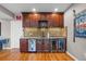 The bar area features dark wood cabinets, granite countertops, and a backsplash at 446 Angus Way, Highlands Ranch, CO 80129