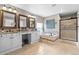 Bathroom featuring double sinks, a tub, a walk-in shower, and natural light at 446 Angus Way, Highlands Ranch, CO 80129